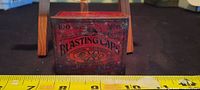 Front of red Beaver Brand blasting caps tin showing company markings