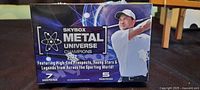 Front view of sealed Skybox Metal Universe Champions blaster box showing product name, 7 cards per pack, 5 packs per box graphic