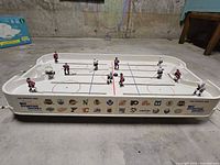 Full view of tabletop hockey game with all players and pucks