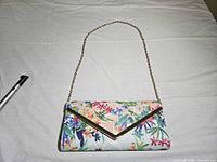Front view of floral envelope clutch with chain strap