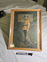 Front view of framed RCMP officer print with frame and glass