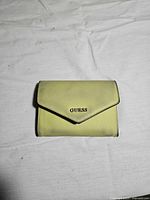 Front view of light green Guess wallet, logo visible