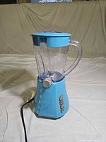 Full view of light blue Hamilton Beach blender with jar, lid and power cord
