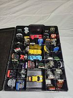 Open case showing compartments filled with cars