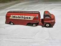 Left side view of red Mobilgas tanker truck showing overall design and decal