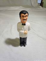 Front view of waiter-shaped pepper grinder