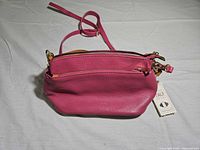 Front view of pink leather purse showing texture and shape