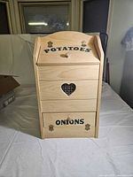 Front view showing full bin with lettering and heart vent