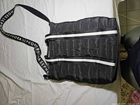Front view showing quilted body, white stripes, and SEPHORA shoulder strap