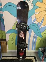 Top of snowboard with bindings and stickers
