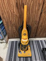 Front view of orange Dirt Devil upright vacuum showing entire unit