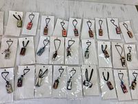 Group shot of 30 individually bagged domino pendant necklaces