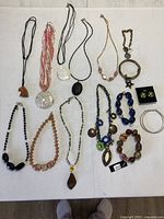 Overview of all fifteen jewelry pieces laid on table