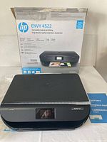 Printer and original box front showing model and features