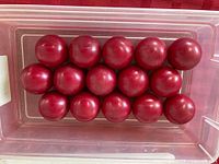 Top view of all 15 red snooker balls in clear container