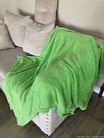 Blanket draped over sofa showing overall size and color