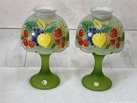 Front view of both Westmoreland frosted green glass fairy lamps