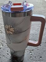 Full view of floral 40oz travel mug with handle