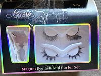 Front of boxed magnetic eyelash and curler set showing contents