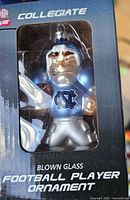 Front of boxed North Carolina Tar Heels blown glass football player ornament