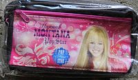 Front view showing Hannah Montana graphics and magenta zipper, sealed in plastic
