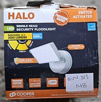 Front of retail box showing Halo single-head security floodlight and key specifications