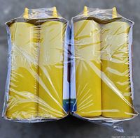 Front view of two shrink-wrapped bundles showing four bottles each