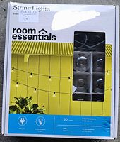 Front of sealed box showing Room Essentials branding, 20 lights specification and product image