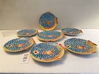 Seven fish-shaped plates arranged on table