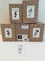 Front view of five ornament boxes showing artwork and labels