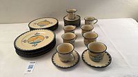 Full set showing stacked dinner plates, cups on saucers and extra saucers