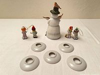Group view of snowman, clown ornaments, and four candlestick sleeves