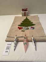 Group shot of table runner folded, ceramic gift box, and three ornaments
