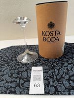 Kosta Boda candlestick beside original tube