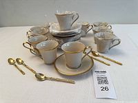 Full set arranged: cups, saucers, spoons; some pieces wrapped