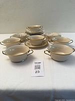 Six bowls with saucers shown, additional sets stacked behind