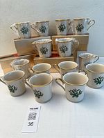 Front view of all 12 mugs with original boxes