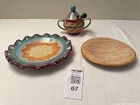 Three MacKenzie-Childs pieces displayed together