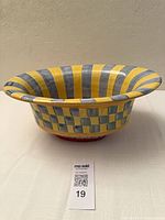 Side view showing exterior checker pattern and flared shape