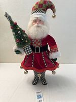 Front view of Santa figure displaying suit, belt, tree and jingle bells