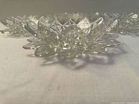 Close view of star-shaped bowl showing petal rim and pressed glass detail