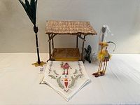 All five items grouped: shelter, one palm, runner, camel, second palm wrapped