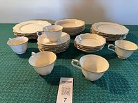 Full set laid out showing cups, saucers, plates, bowls