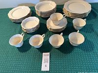 Full dinnerware set laid out showing cups, saucers, plates, bowls