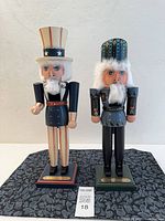 Front view of both nutcrackers on bases showing overall design and condition
