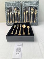 Two sealed 20-piece Spun Gold boxed sets and one opened box displaying utensils
