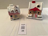 Front view of both ceramic music box houses