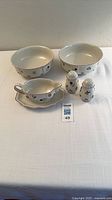 Full lot showing two bowls, gravy boat on base, salt and pepper shakers