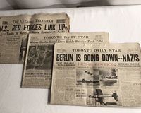 Three newspaper front pages laid out