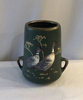 Front view showing full vase with ducks and handles